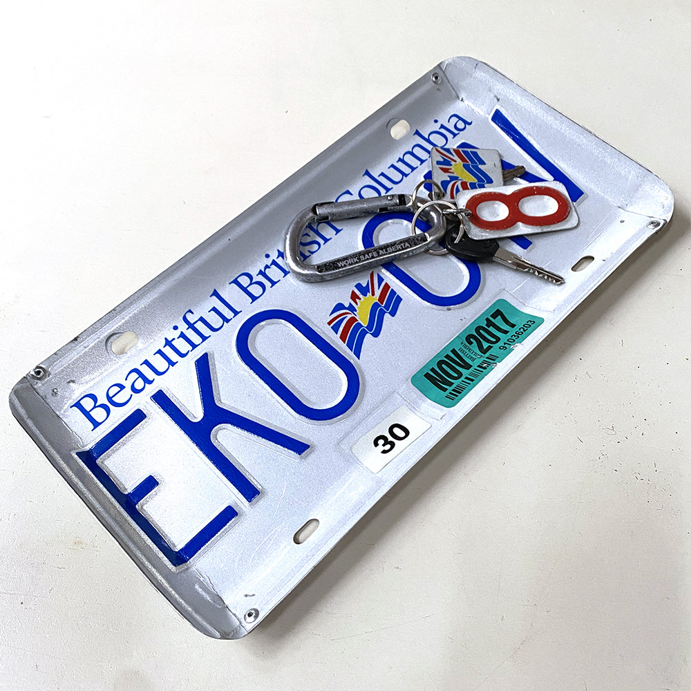 Tray for holding keys or coins that is made from a recycled BC license plate. Edges are bent and riveted in four corners to make its tray shape.