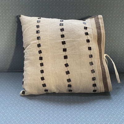 Linen pillow with leather detail in neutral